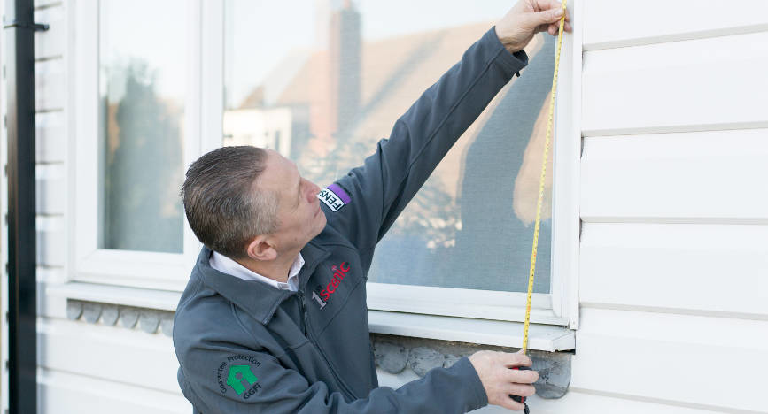 Staff-measuring-space-for-replacement-windows